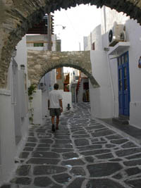 Ryan Martell walking down an alley in Naoussa, Paros, Greece
