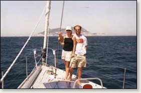 Tamra Strentz and Ryan Martell on the bow of Valkyrie, with Gibraltar in the background